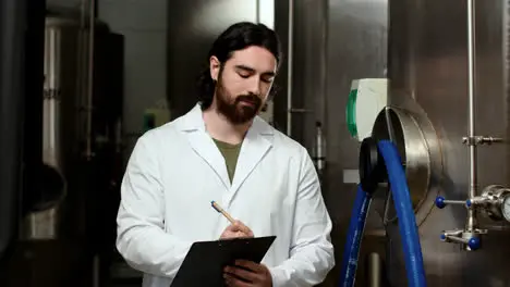 Man with clipboard at brewery