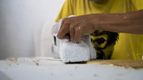 Handheld Close Up Shot of Power Tool Being Used On a Polystyrene Surfboard