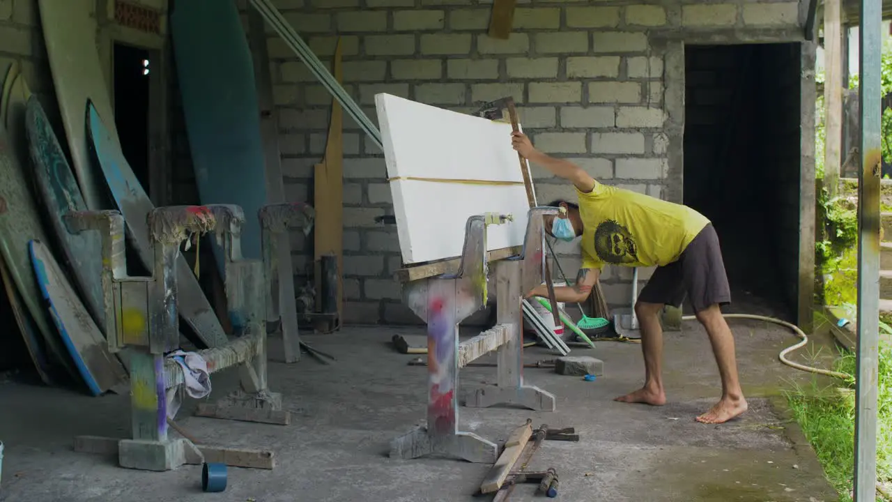 Handheld Wide Shot of Surfboard Shaper at Their Workshop