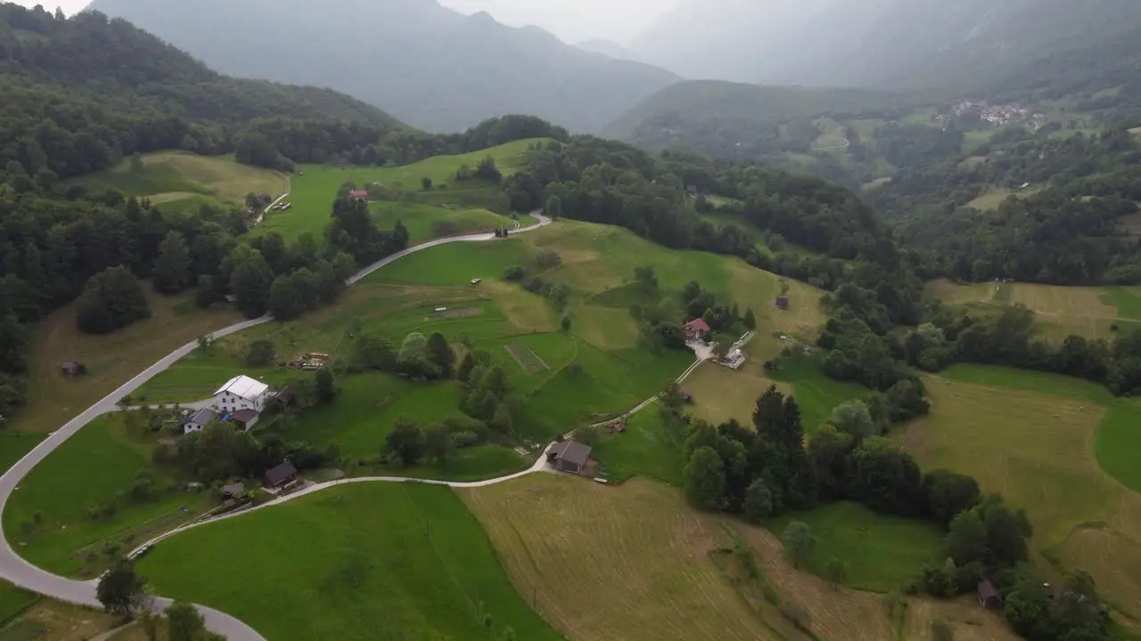 Rolling green hills and foggy morning at Dreznica village Slovenia countryside