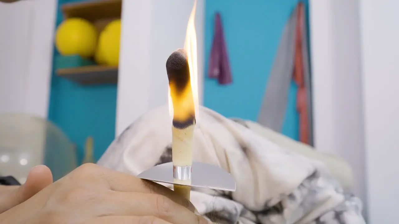 Close-up of ear candling to remove the buildup of ear wax