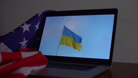 flag of Ukraine on laptop and the United States of America