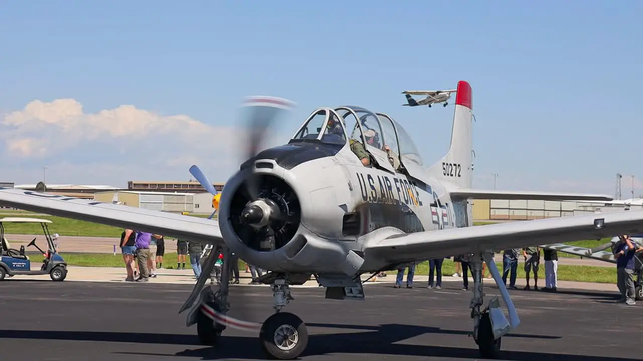 North American T-28 Trojan vintage aircraft taxiing and turning towards a parking space at an airshow at the Centennial Airport in Colorado