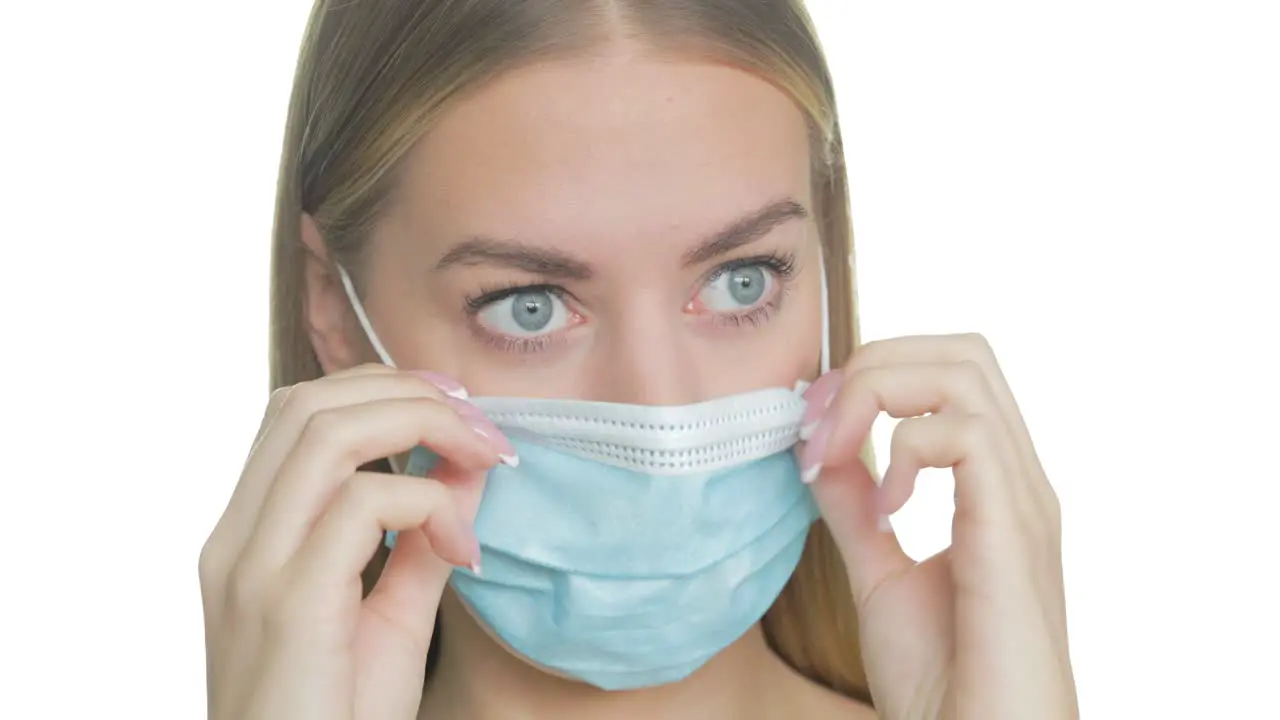 Frustrated woman adjusts her uncomfortable mask close-up