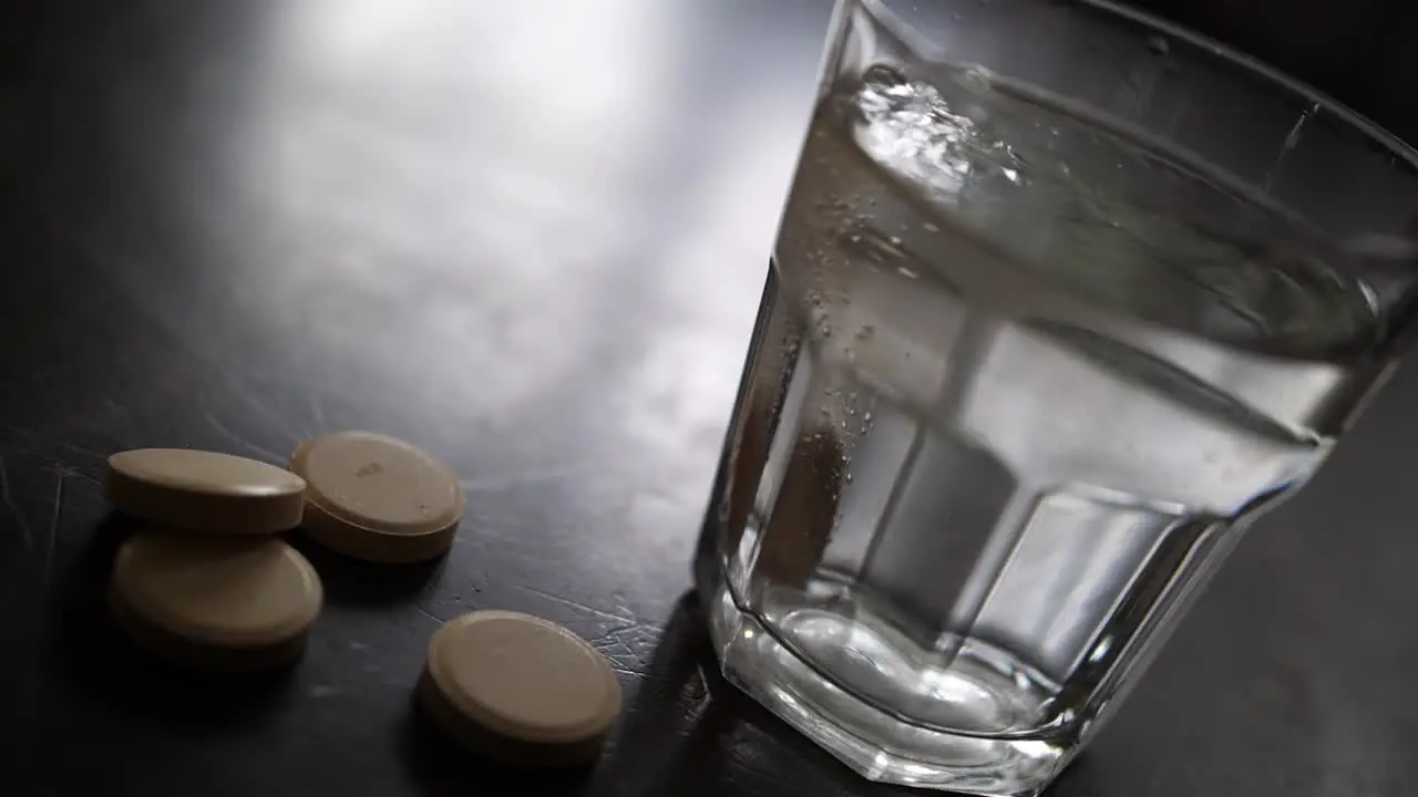 Effervescent nutritional vitamin C tablet dissolves in glass of water