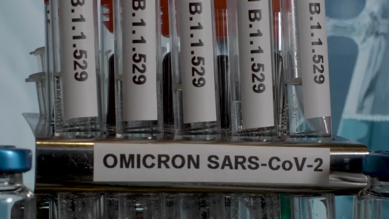 Close up tilt shot of a row of test tubes labelled with the new Covid 19 variant Omicron the new mutation identified in South Africa B