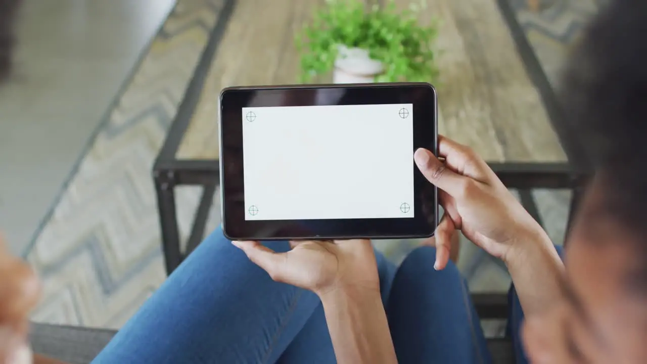 African american mother and daughter using tablet with copy space on screen