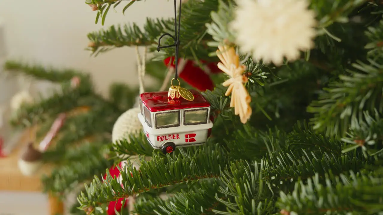 Miniature Danish Pølsevogn ornament adorning a Christmas tree