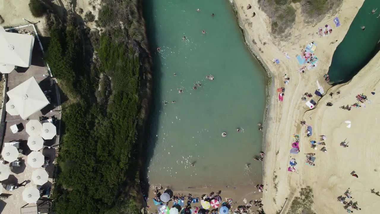 Top down aerial over Canal d'Amour swimming tourists Sidari Corfu Greece