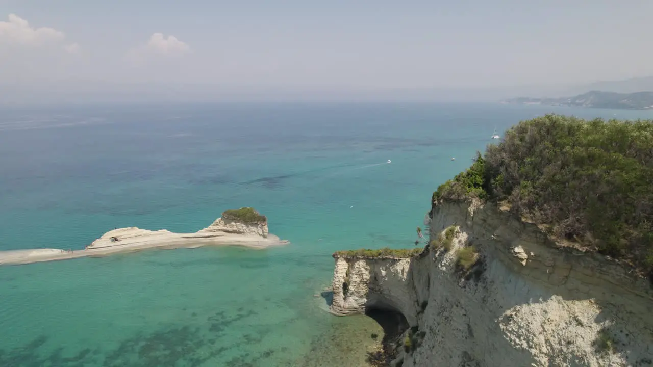 Drone flight along imposing sandstone sea cliffs on Sidari coastline Corfu