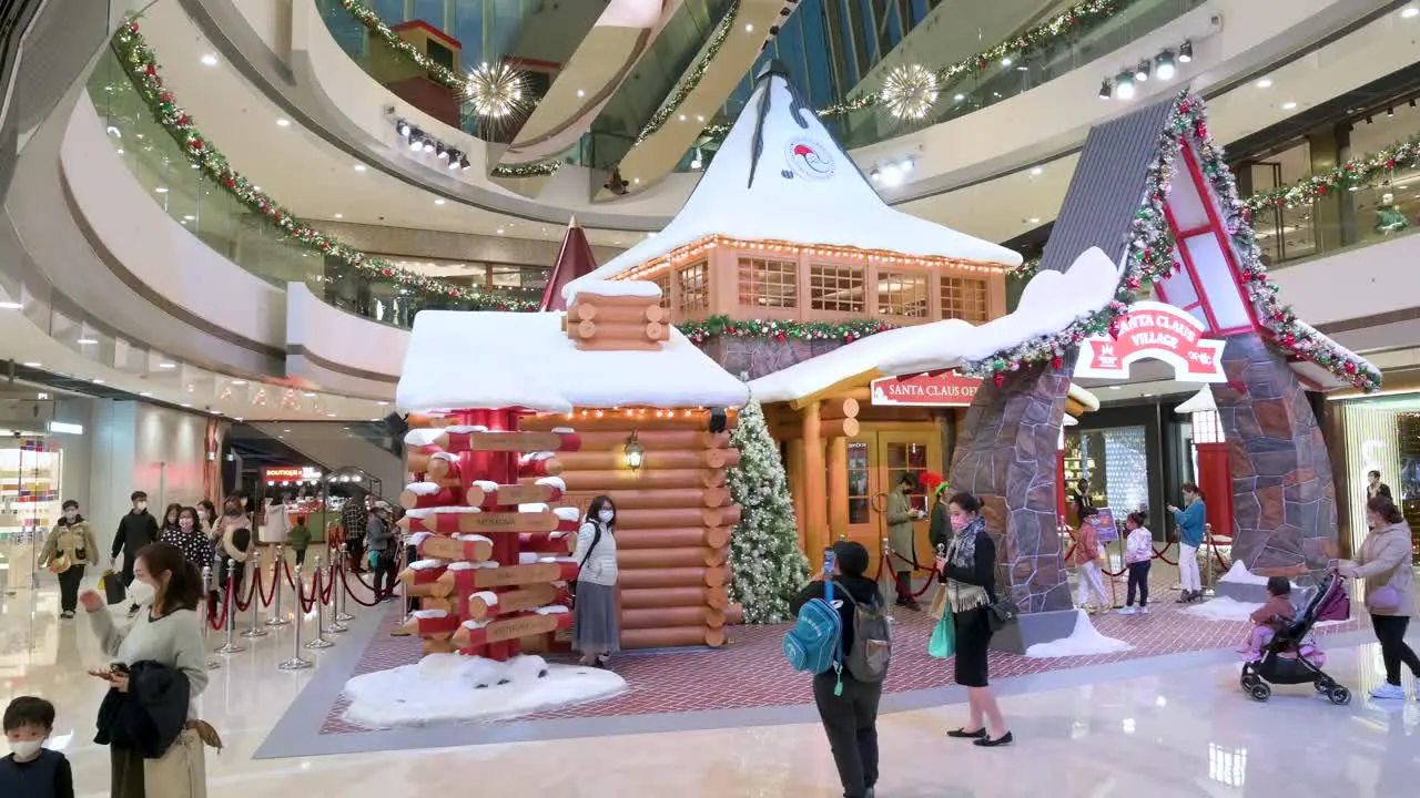 Shoppers walk past a Christmas installation event at a high-end shopping mall in Hong Kong