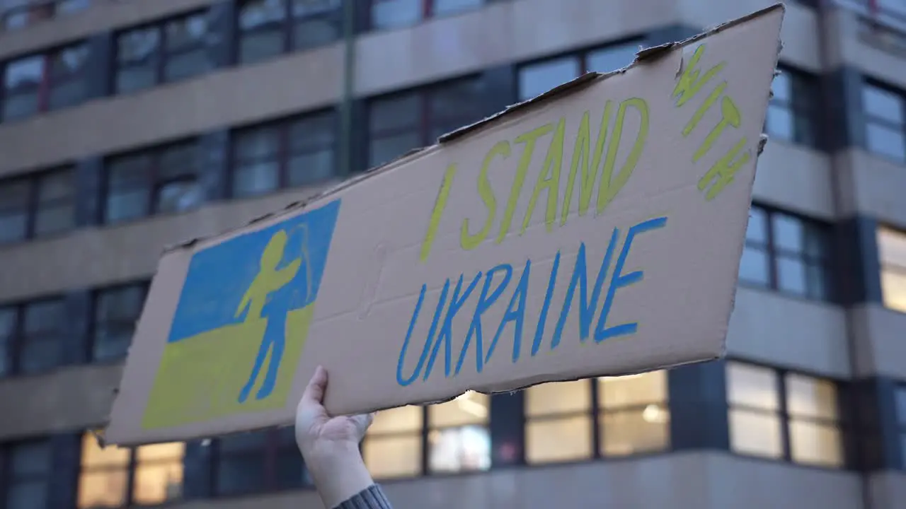 I Stand With Ukraine Message on Board in Hand of Protestor on Demonstration Against War and Russian Military Actions and Invasion