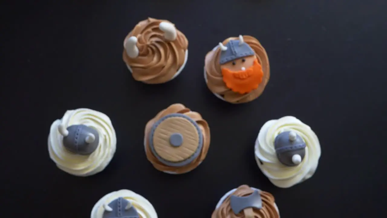 Topdown motion over Viking theme cupcakes on Black table Rack focus