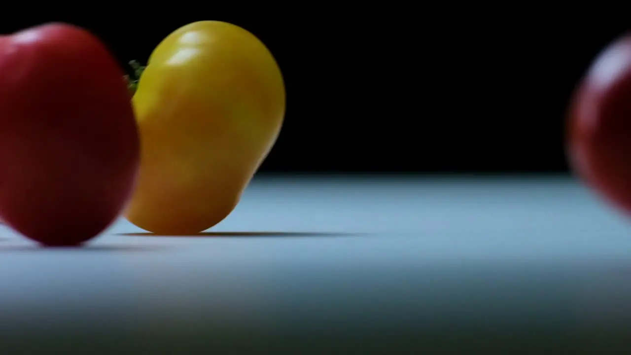 Slow Motion of delicate Tomatoes dropping onto a White Tabletop