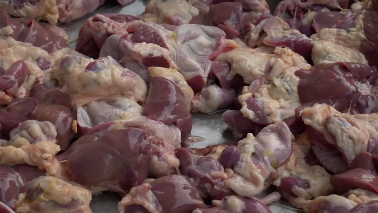 raw fresh chicken gizzard and livers on counter ready for sale