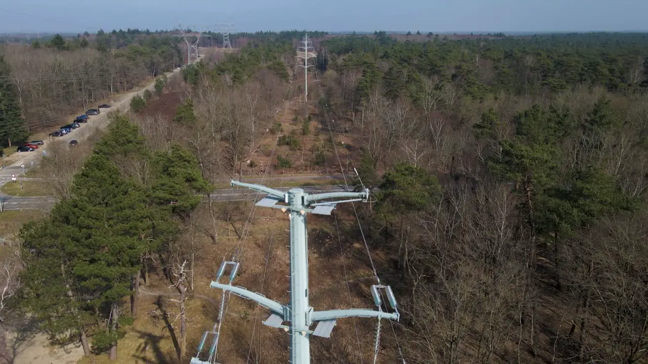 Aerial Upwards view of high-voltage lines in the woods Electricity distribution station