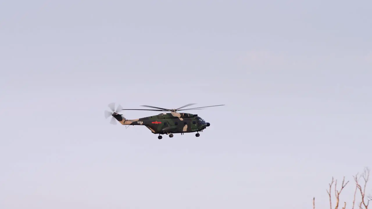 Chinese People's Liberation Army Z-20 Helicopter from Hong Kong Shek Kong Garrison Base Landing Behind Trees