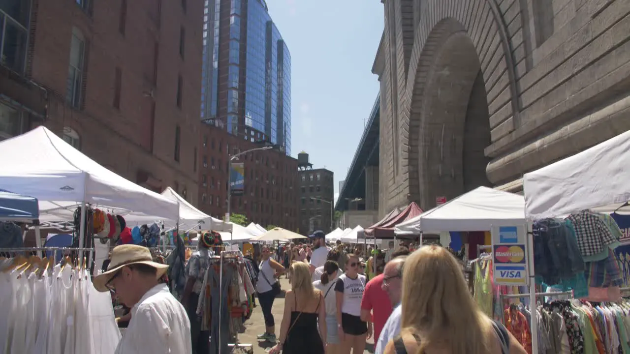 handheld tilt slow motion shot of brooklyn's flea market on a bright sunny summer day