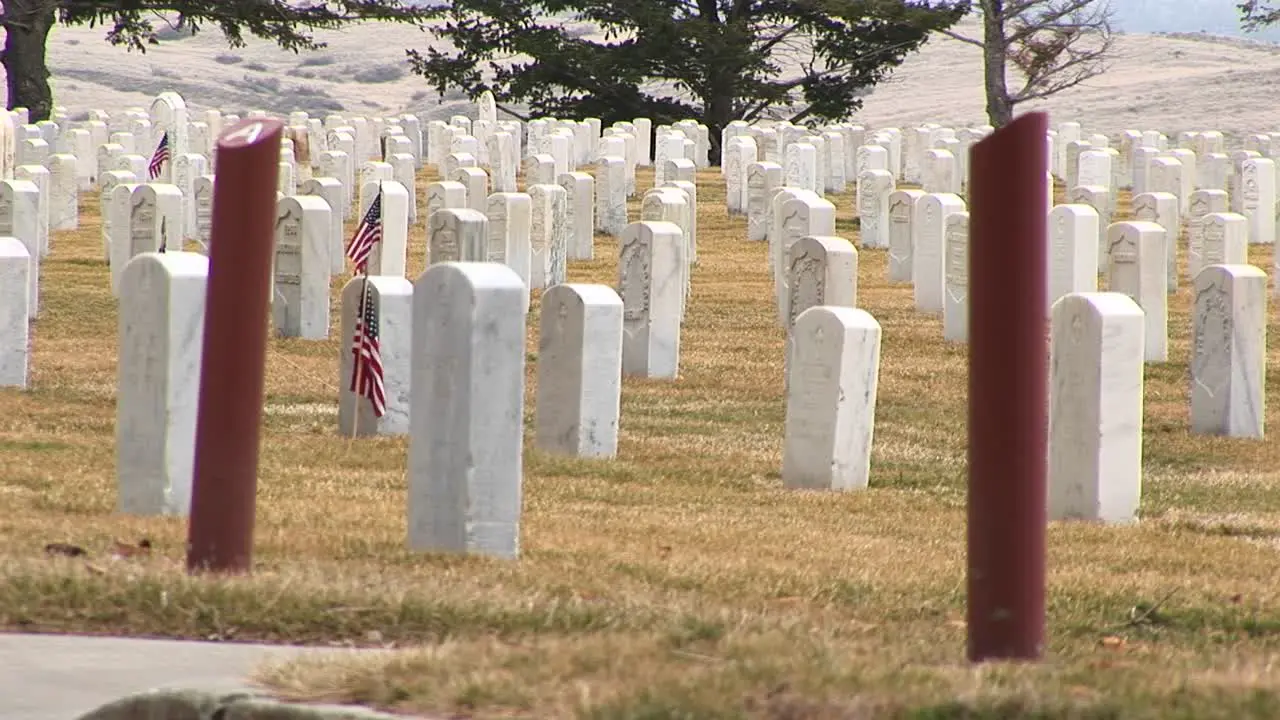 A Detail Of Arlington National Cemetery With White Headstones And Section Markers