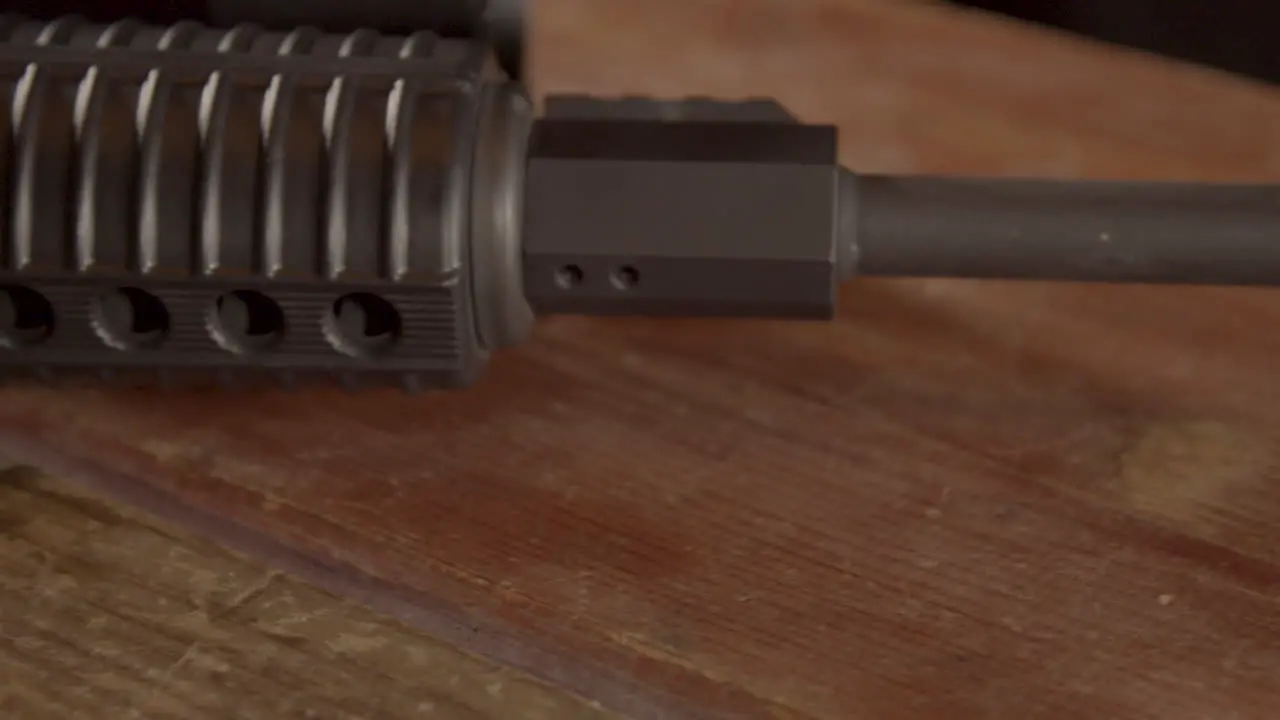 Close dolly over AR-15 barrel on a wooden surface