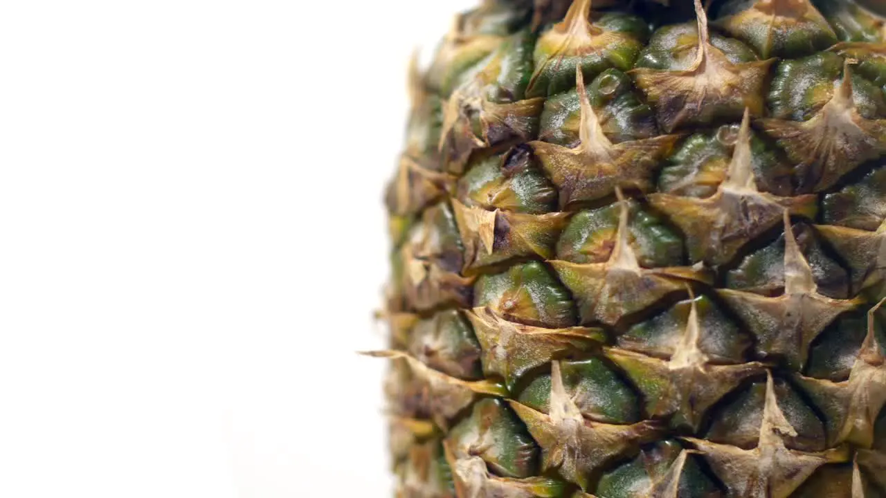 Close up of a pineapple rotating on a white background