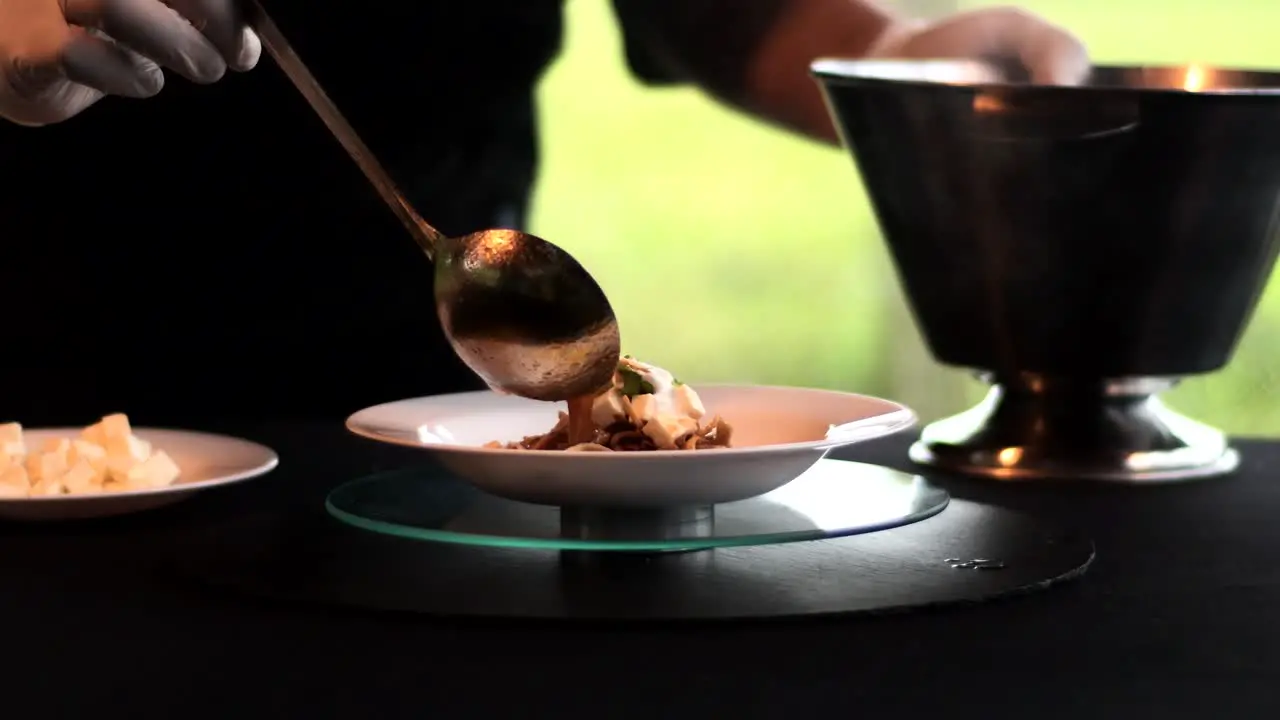 Hands with a spoon putting Mexican soup in a bowl