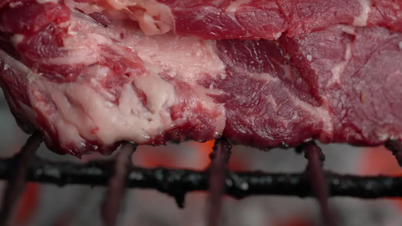 Close-up of grilled fillet steak over charcoal grill