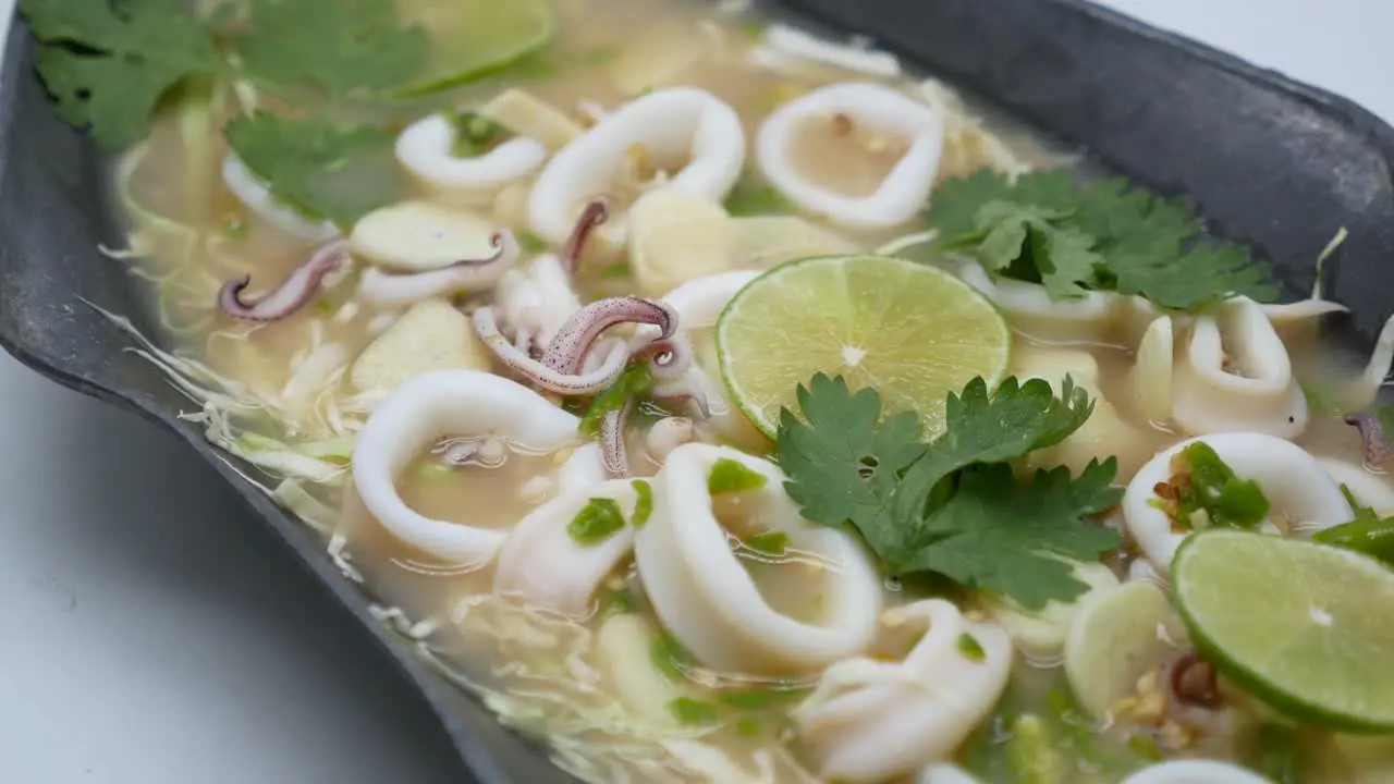 Close-Up Footage of Hot and Sour Squid in Chilli Garlic and Lime Soup