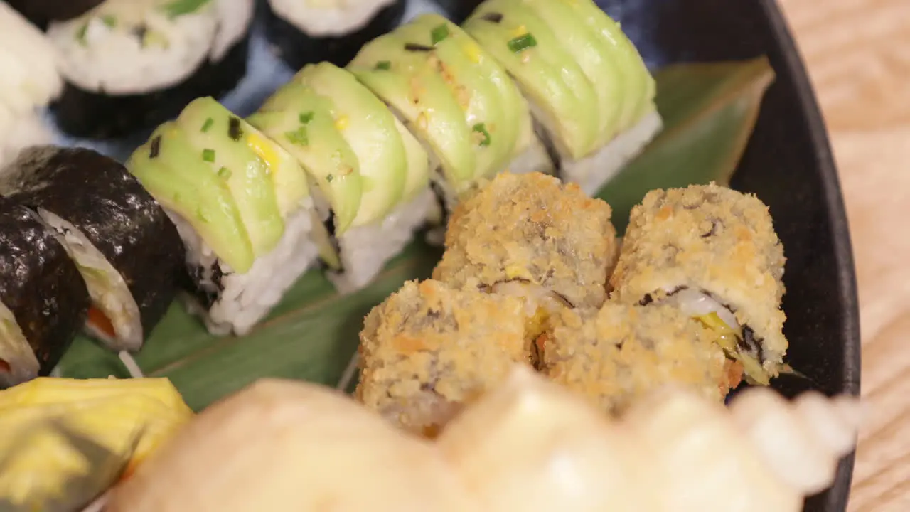 Mixed Serving Of Fresh Sushi Drizzled With Oyster Sauce In A Platter Closeup Shot Slow Motion