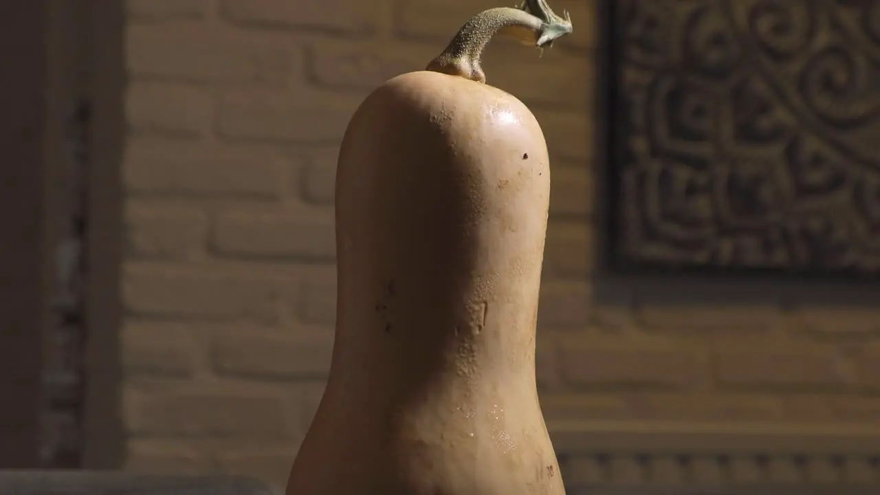 Healthy seasonal butternut pumpkin on kitchen island close up