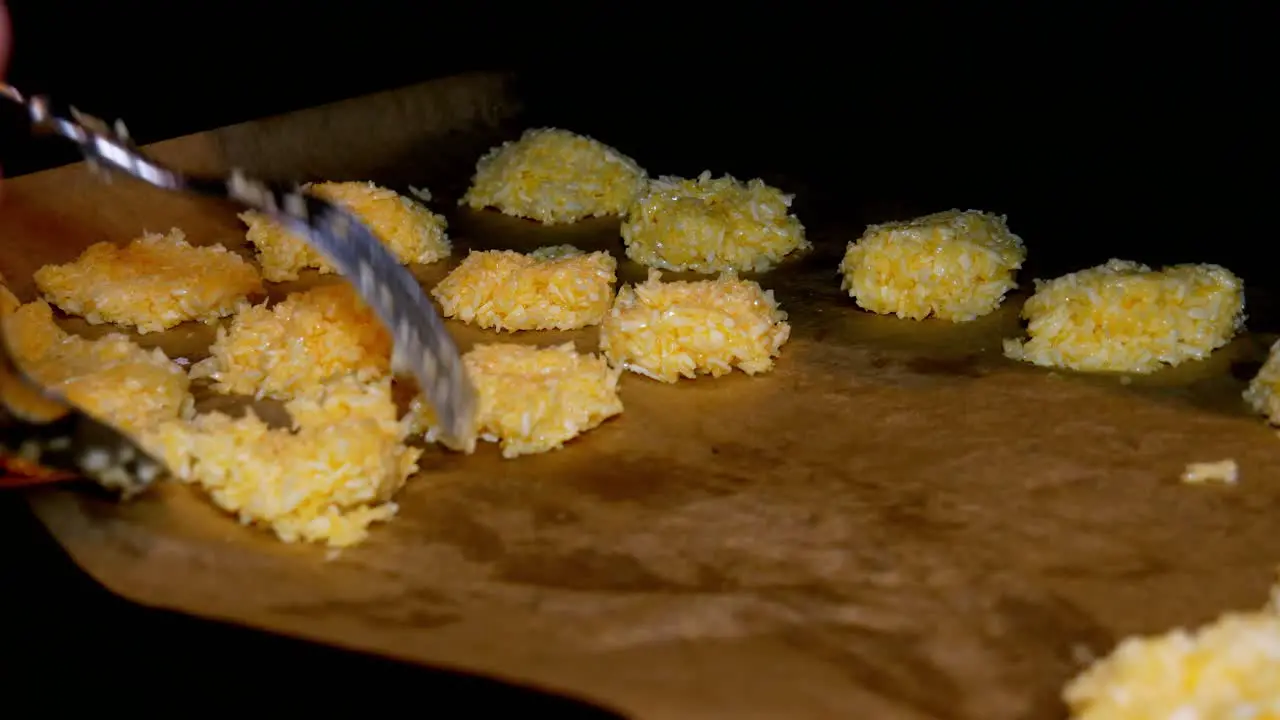 Forming coconut cookies on baking paper to cook in oven for delicious sweets