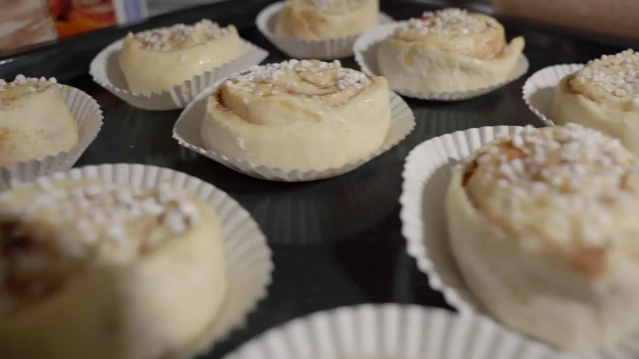 Medium shot of unbaked cinnamon buns on a tray