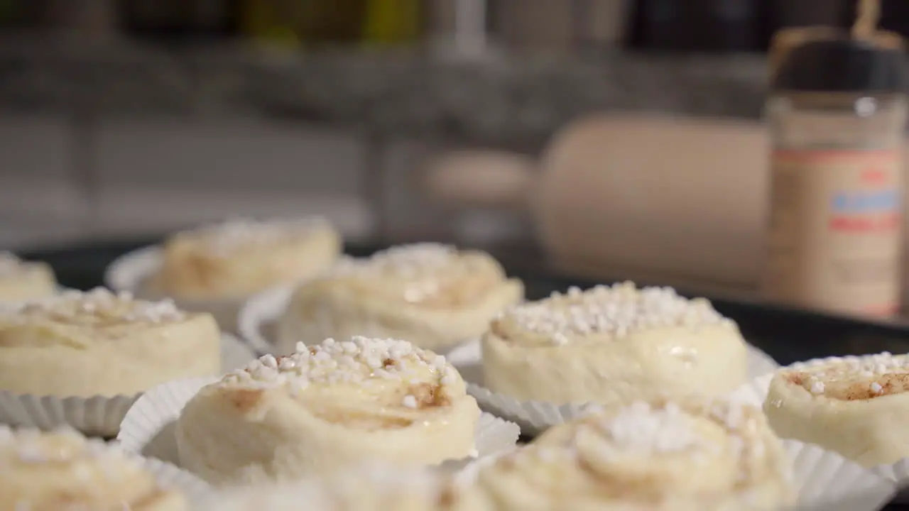 Slide shot of cinnamon buns on a tray with baking utensils