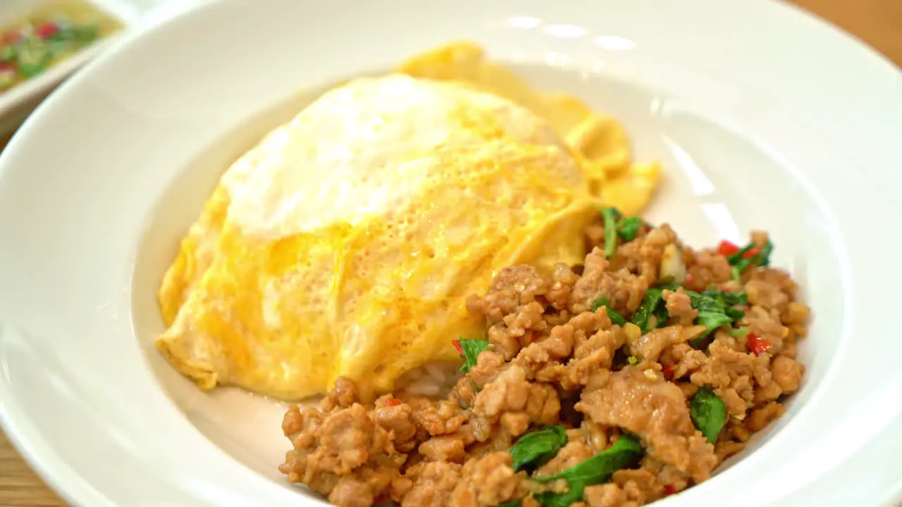 stir-fried pork and basil with creamy omelet on rice asian food style