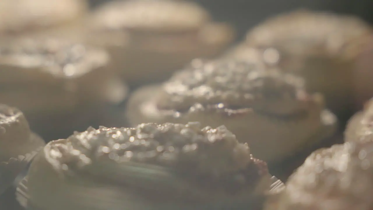 Close up of cinnamon buns getting baked in the oven