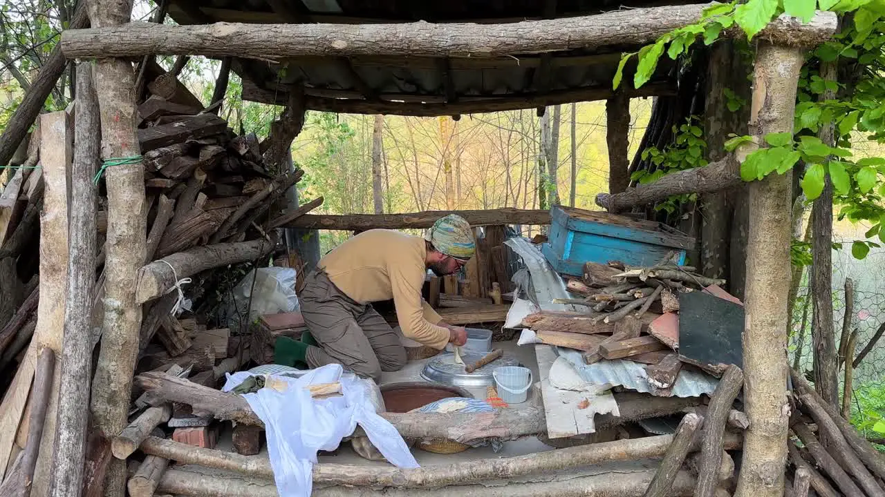 A man is prepare oven to make traditional bread in ground clay oven in forest village mountain rural area middle east Asia