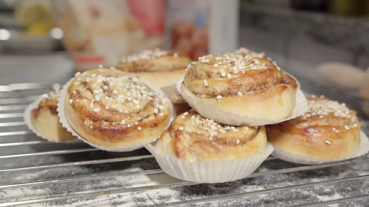 Male hand putting back a cinnamon bun in the fore ground