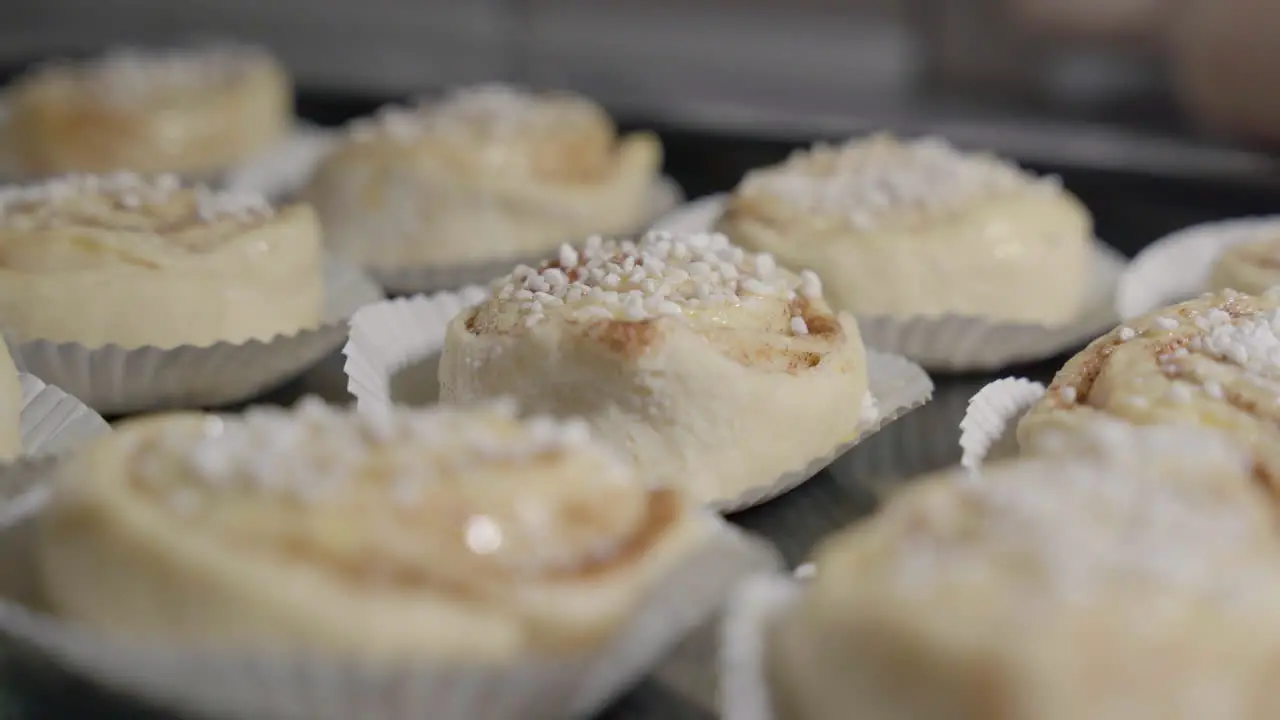 Low angle static close up of cinnamon buns with focus pulling