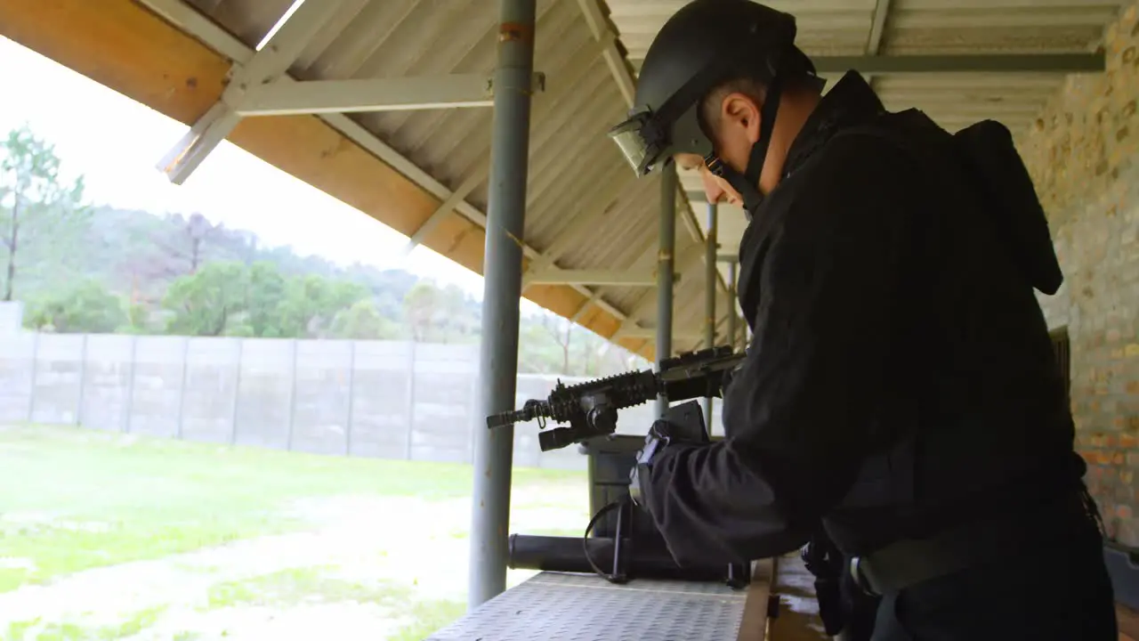 Side view of young caucasian military soldier loading rifle during military training 4k