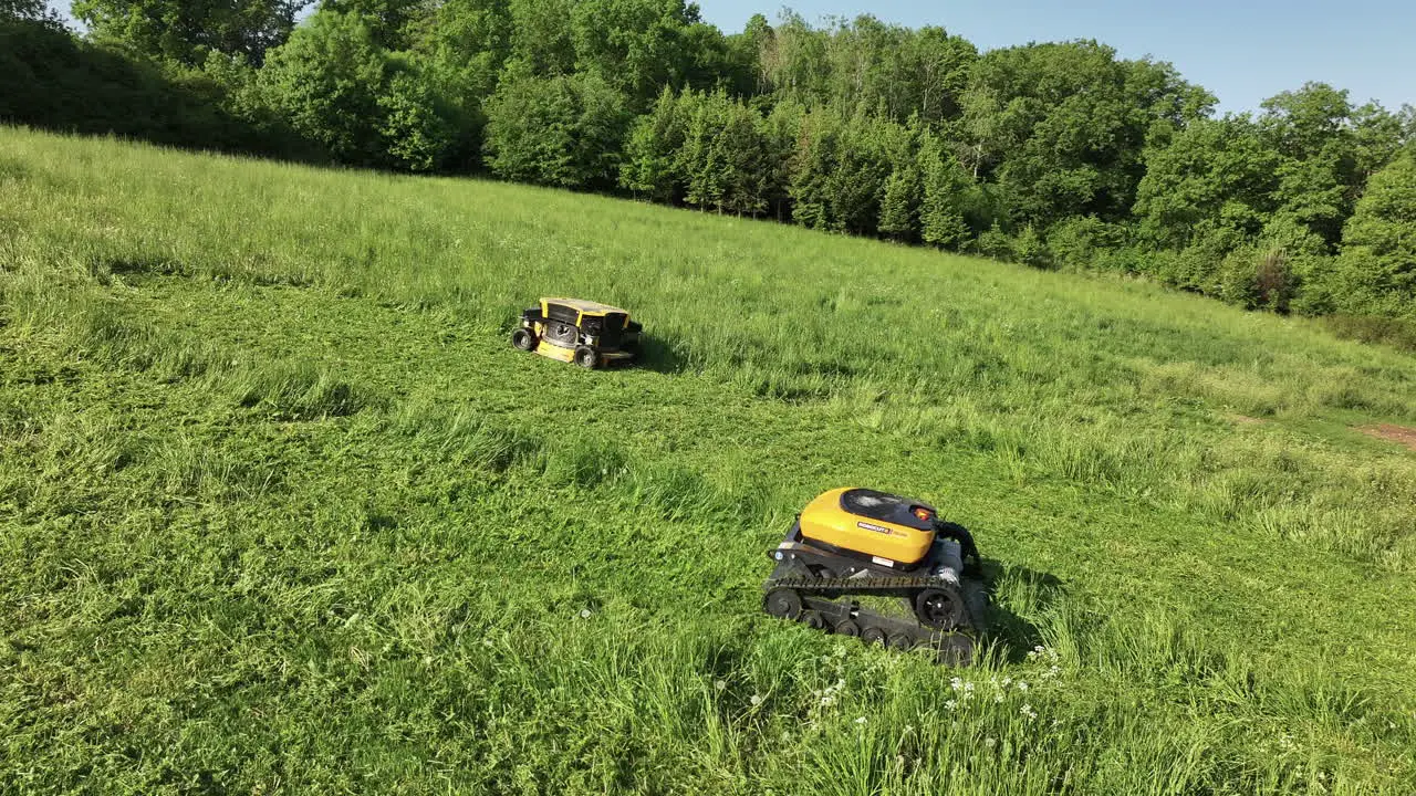 Drone Shot of Robotic Lawn Mowers Mowing Grass on Sunny Summer Day Modern Agriculture Concept