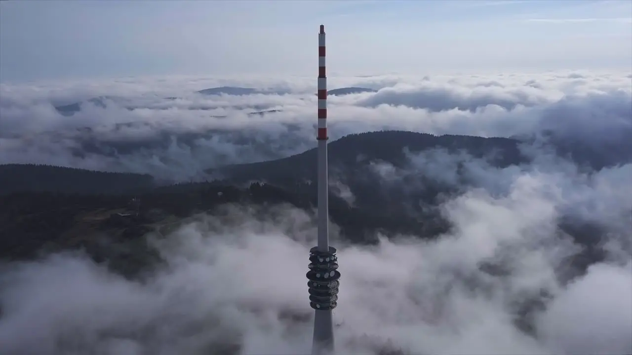 Aerial flyby shot of a big broadcasting tower on the black forest mountain Hornisgrinde