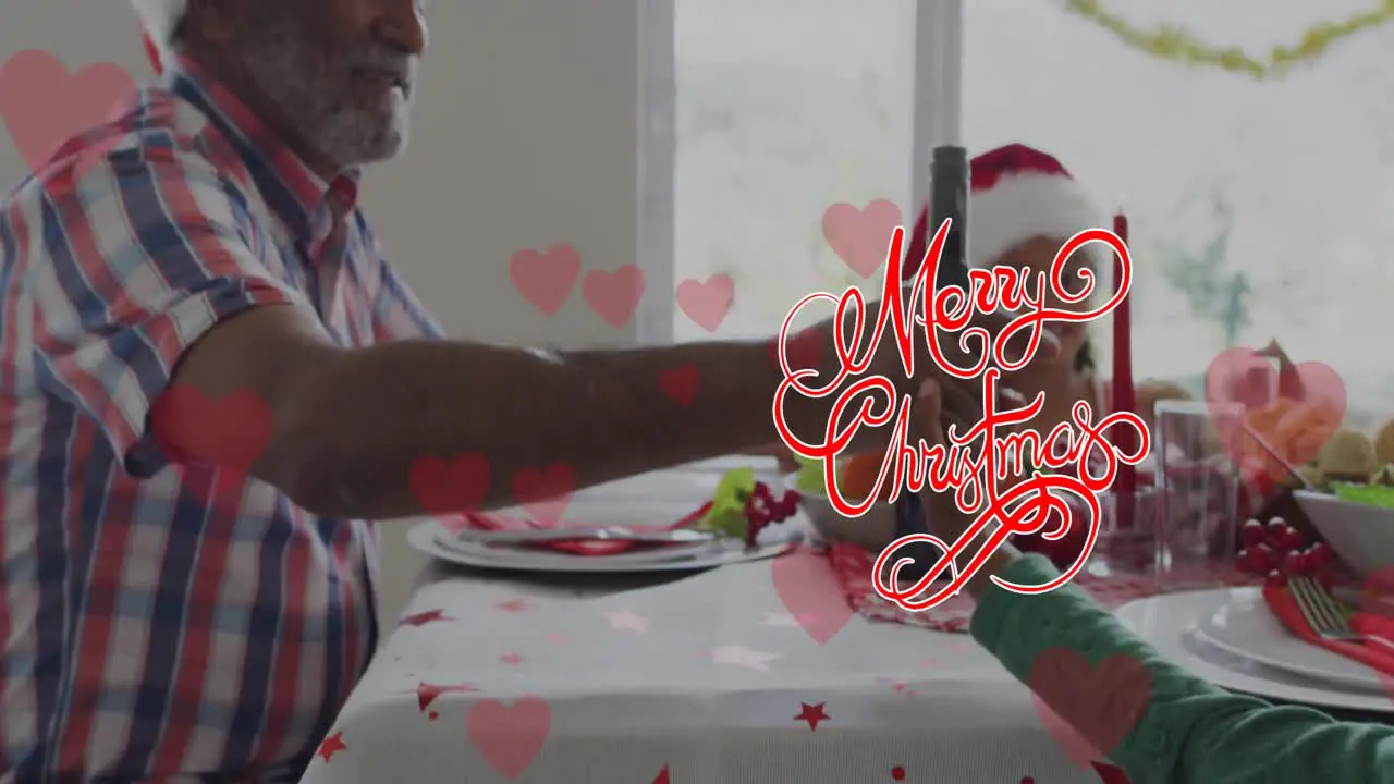 Animation of merry christmas over african american grandfather and grandchildren at table