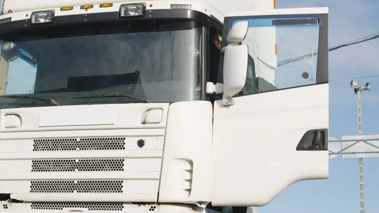 Cuc Worker With Vest And Cap Getting On A Truck In A Logistics Park