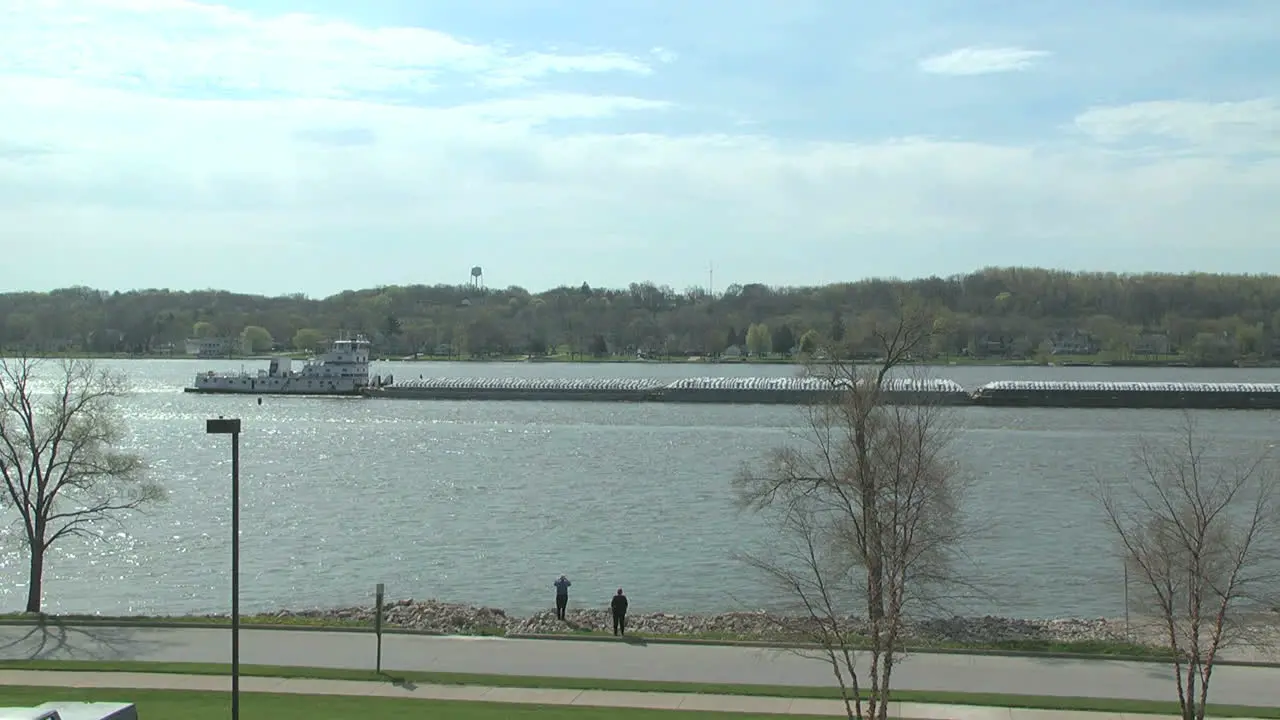 Iowa Le Claire Barge moves on the Mississippi River