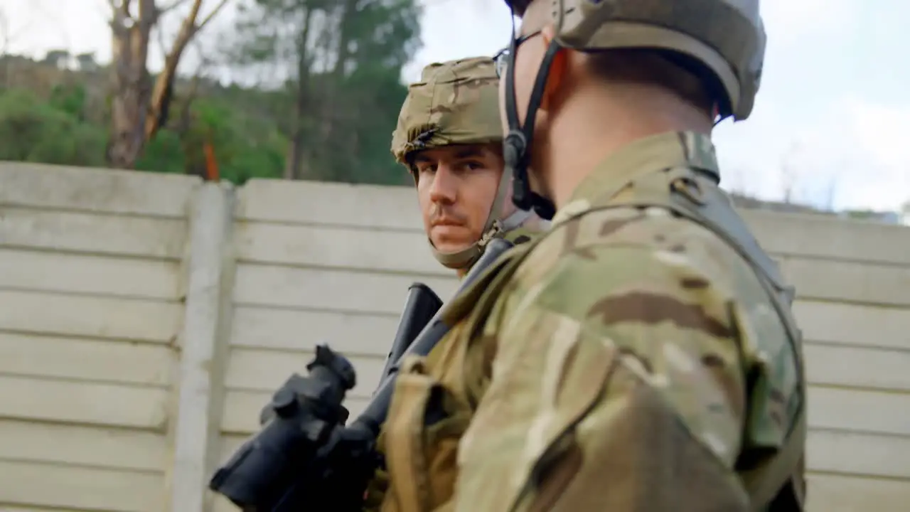 Side view of caucasian military soldiers rifle training in fields during military training 4k 