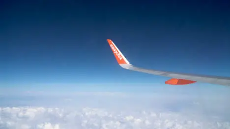 View From Plane Window Of Blue Sky And Clouds On Flight To Summer Holiday Vacation 1