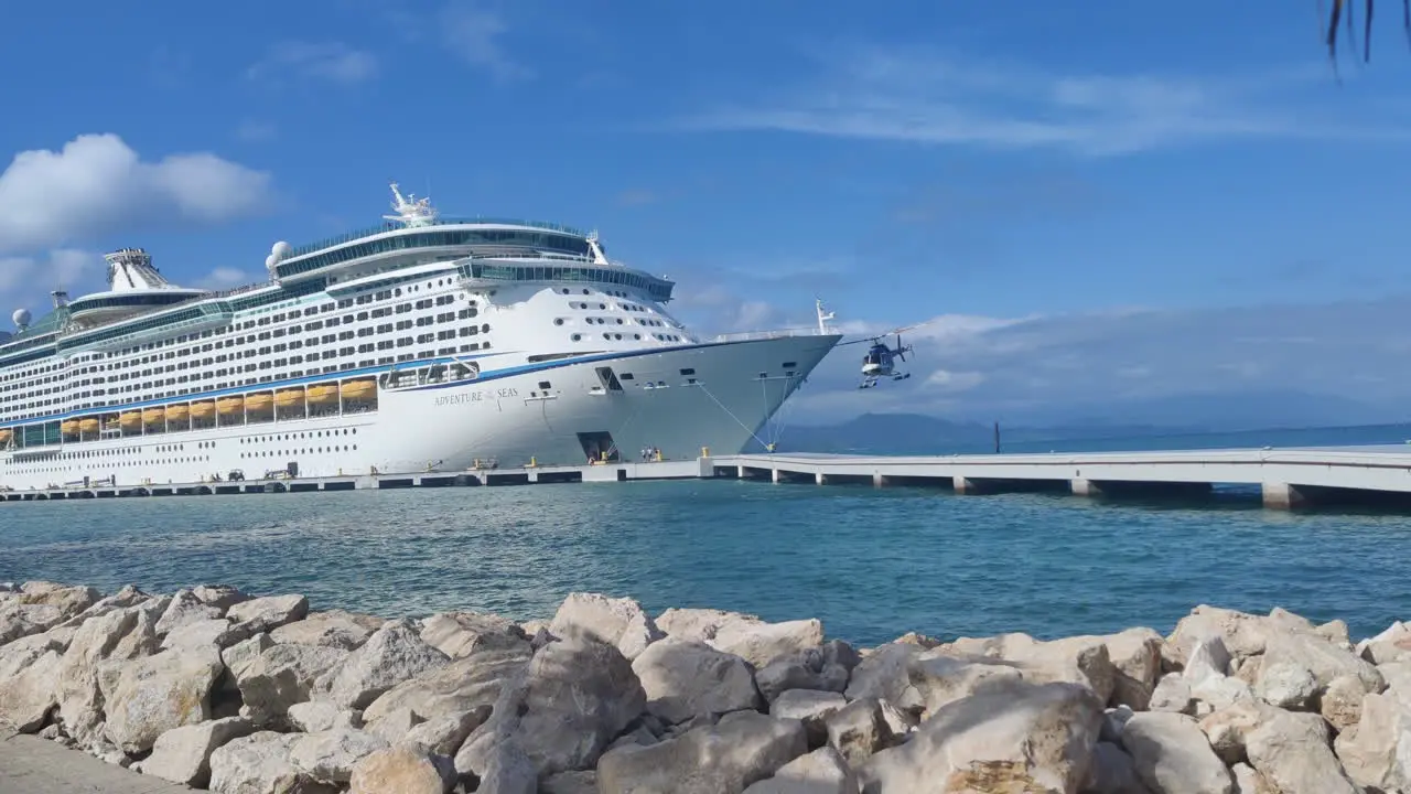 Witness the thrill helicopter takes off from pier adjacent to massive cruise ship adding an exhilarating touch to the Caribbean island experience