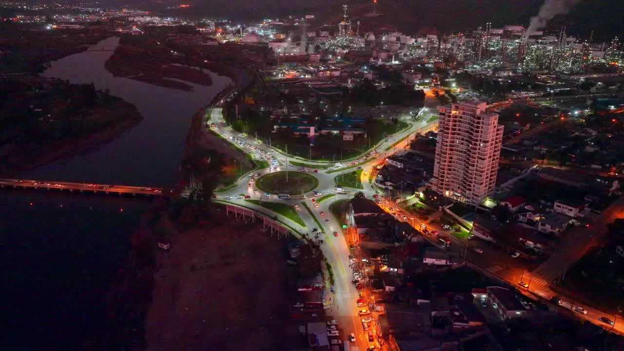 Aerial panorama view of Concón at night traffic in roundabout with oil refinery plant as background Chile