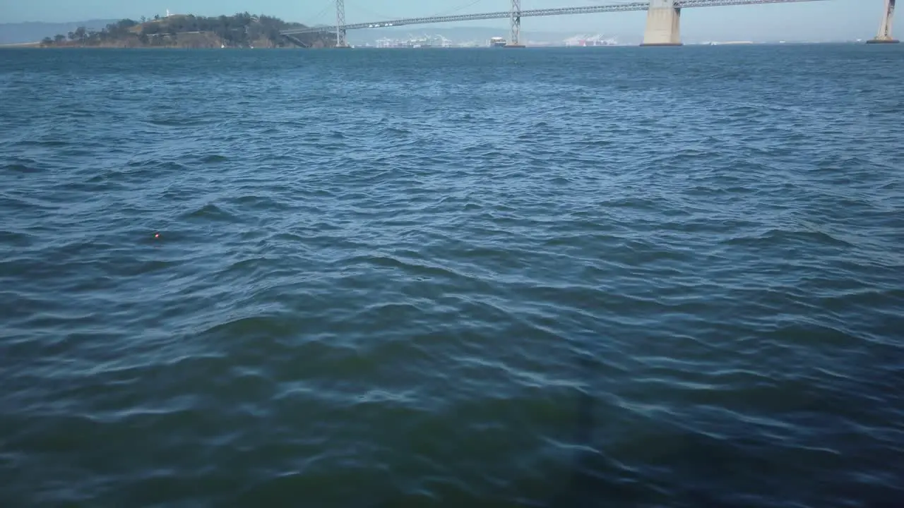 Gimbal shot tilting up to the Bay Bridge in San Francisco California in slo-mo