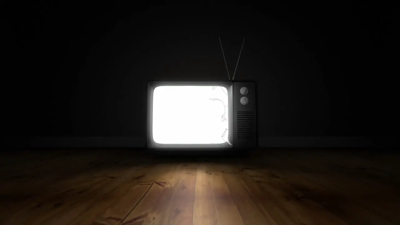 Abstract shapes on television screen over wooden surface against black background